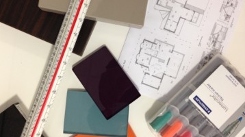 Image of design tools; blueprints, centering ruler, glass samples and markers