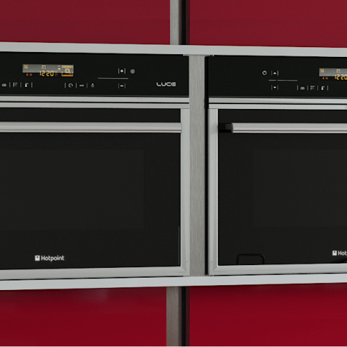 Image of built in dual ovens with red cabinetry