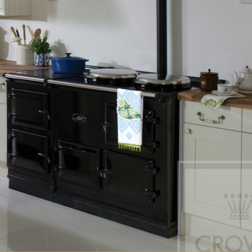 Image of black range cooker with white cabinets and wood countertops