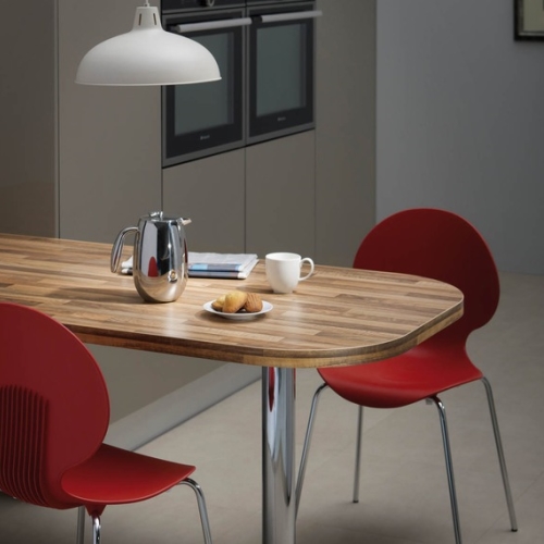 Image of wood laminate kitchen table with red chairs